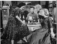 Katharine Hepburn (center) as Bunny Watson, reference librarian, in the 1957 film Desk Set